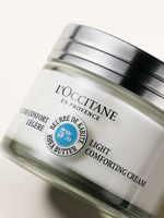 L'Occitane light comforting cream jar on a white background