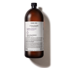 A bottle of l ' occitane liquid on a white background