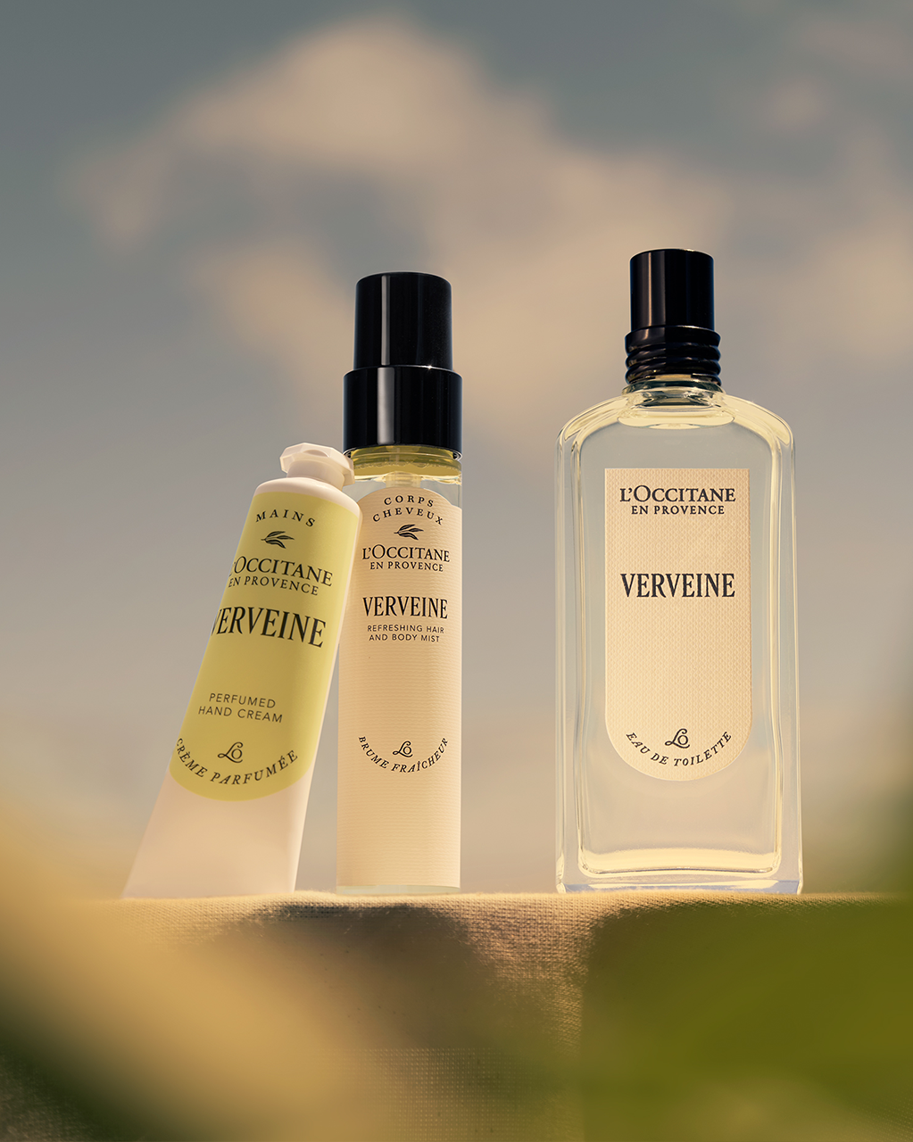 L'Occitane Verveine products including a bottle, spray, and cream against a blurred natural background. - Illustration 5