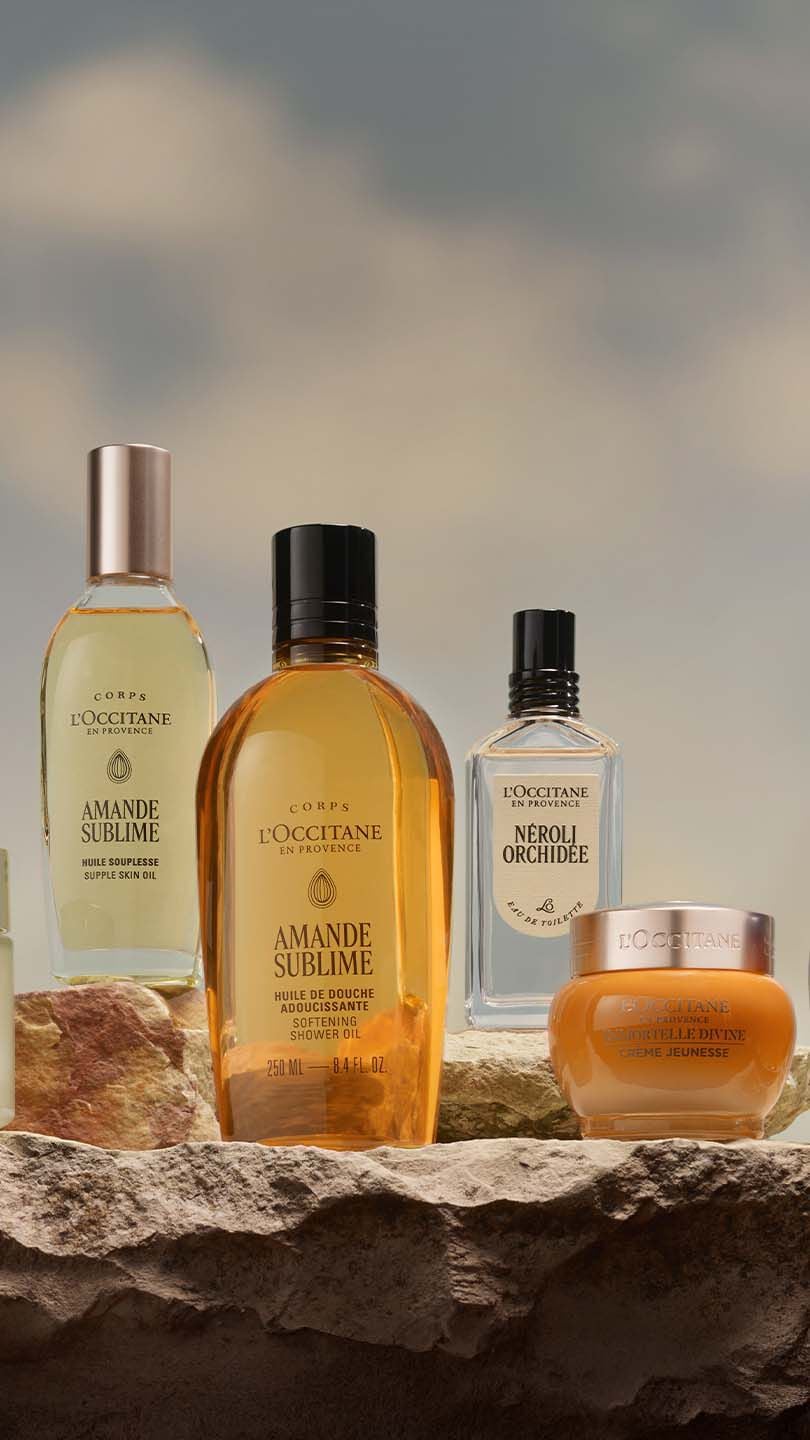 Many different types of skin care products displayed on a rock