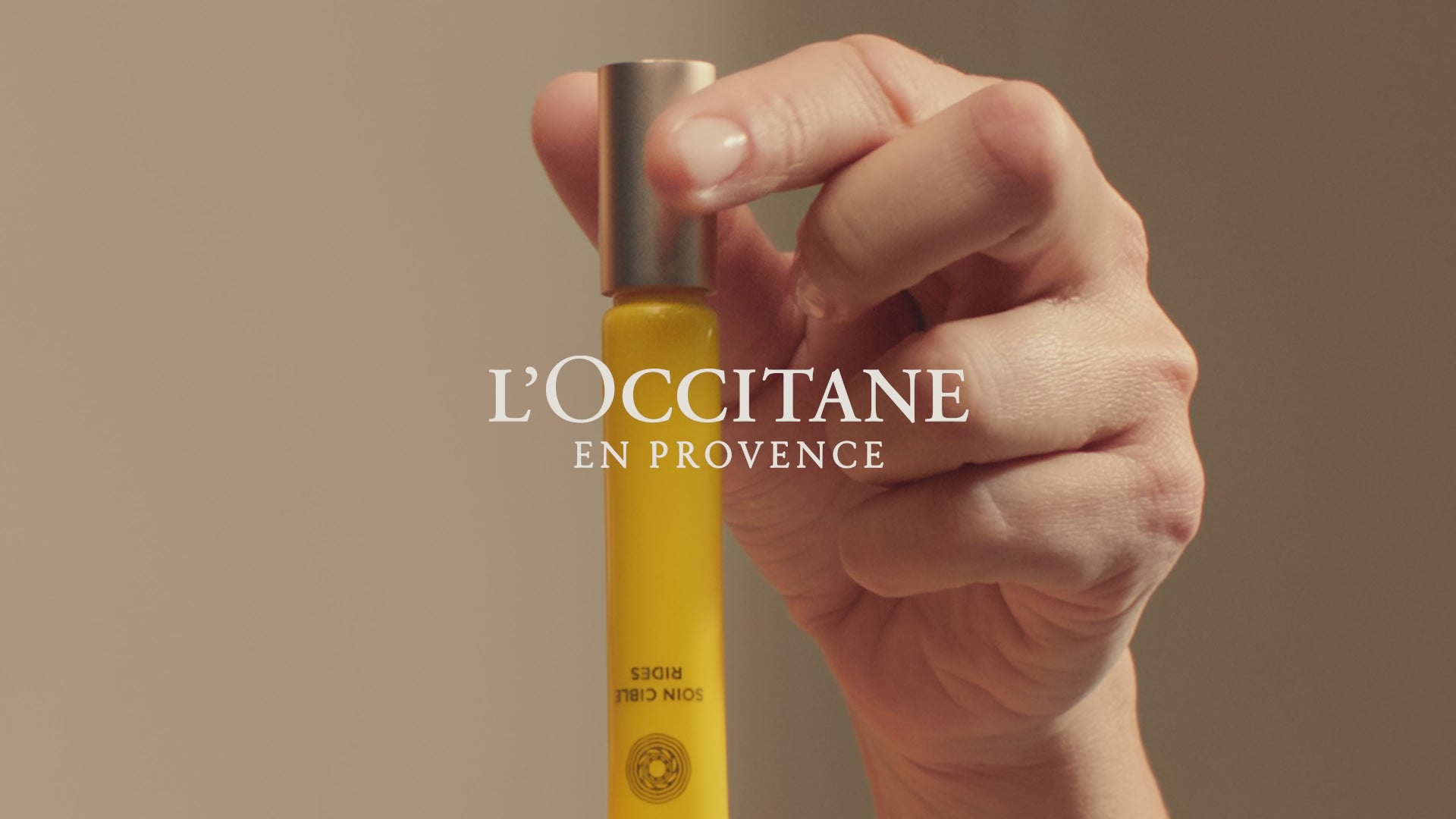 Person holding a bottle of liquid in their hand